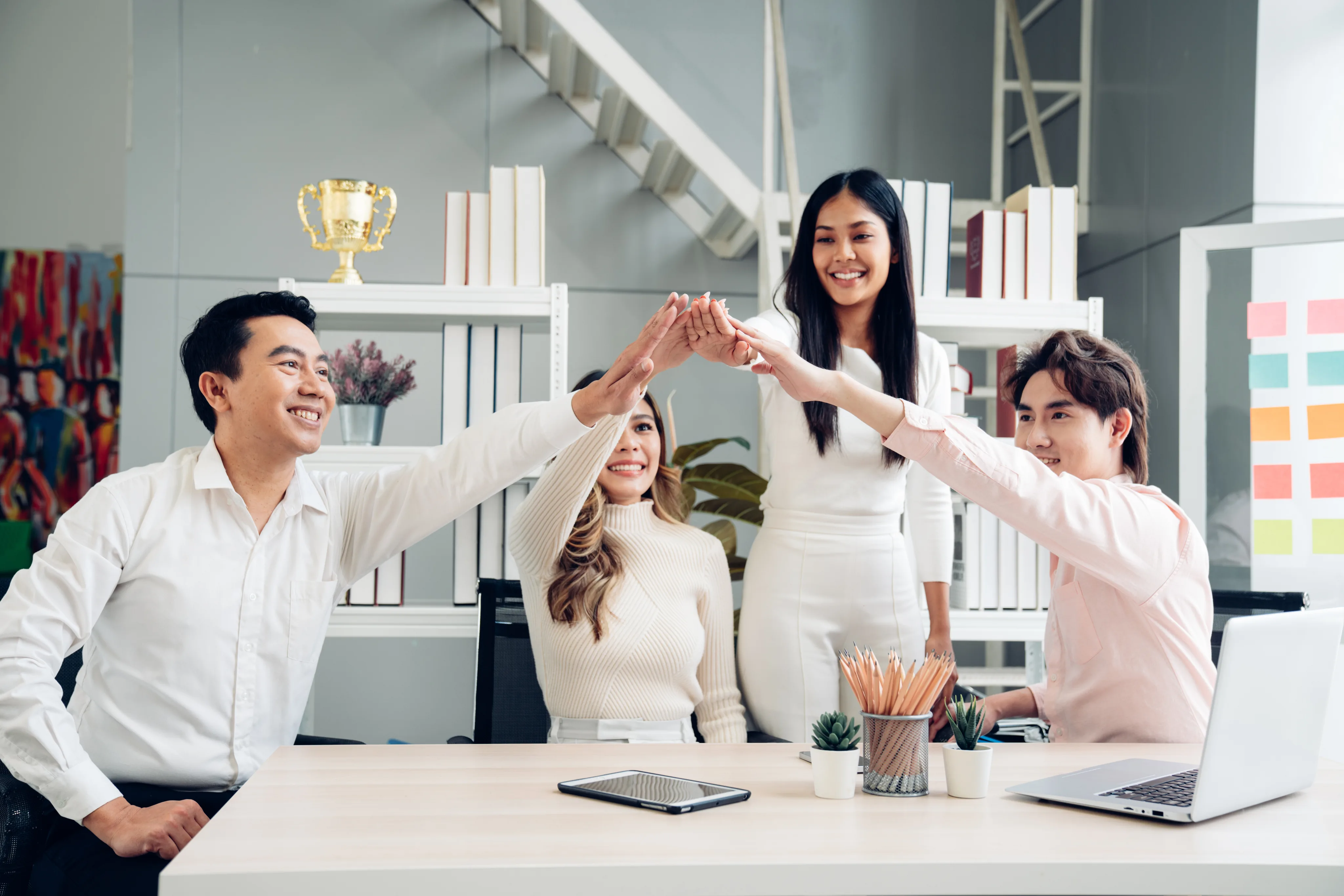 Team celebrating together in a bright office