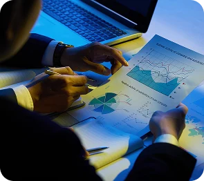 Analyst reviewing KPI charts and performance documents